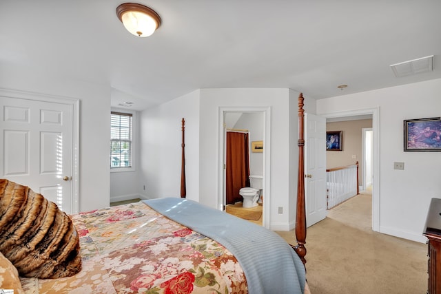 carpeted bedroom featuring ensuite bath