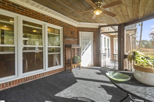 sunroom / solarium with ceiling fan and wooden ceiling