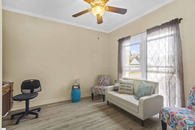 office area with ornamental molding, light hardwood / wood-style floors, and ceiling fan