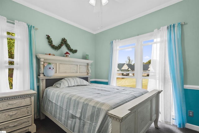 carpeted bedroom featuring crown molding and ceiling fan