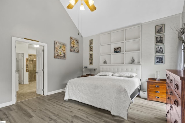 bedroom featuring wood-type flooring, high vaulted ceiling, and ceiling fan