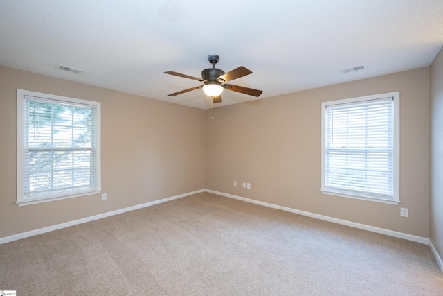 unfurnished room with light carpet and ceiling fan