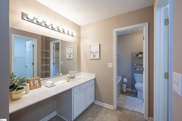 bathroom with vanity, a textured ceiling, and toilet