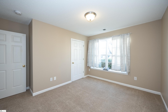 unfurnished bedroom featuring light colored carpet