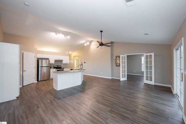 kitchen with white cabinetry, lofted ceiling, stainless steel appliances, dark wood-type flooring, and french doors