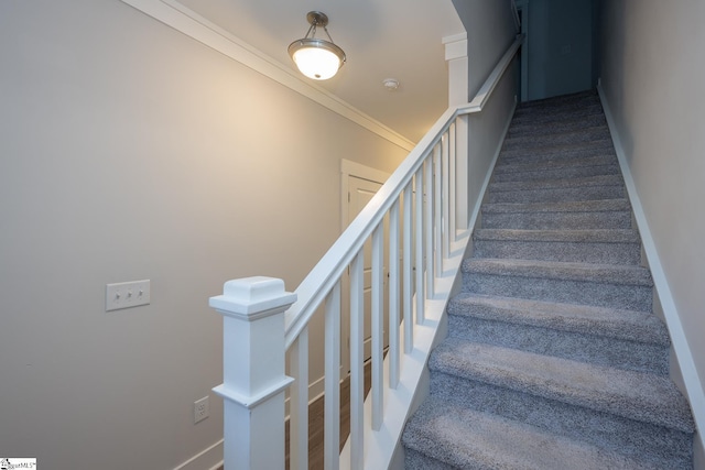 stairway featuring ornamental molding