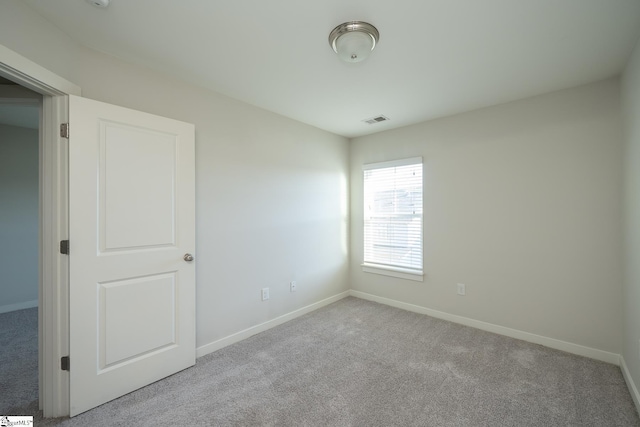 empty room with light colored carpet