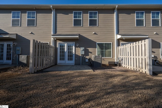 rear view of property featuring french doors, a yard, and a patio