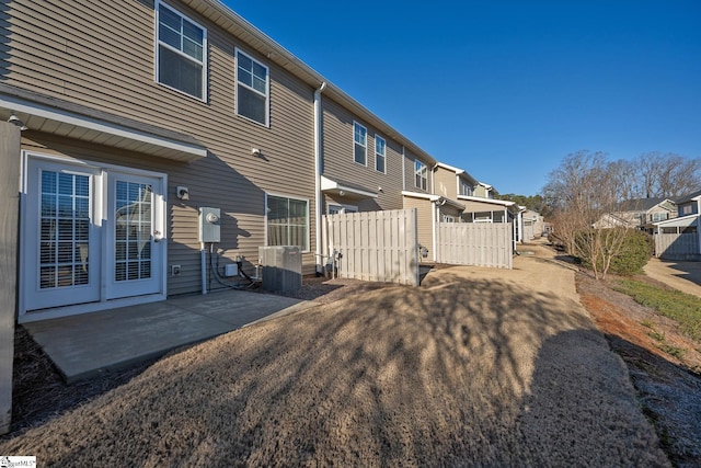 rear view of property with a patio area and central air condition unit