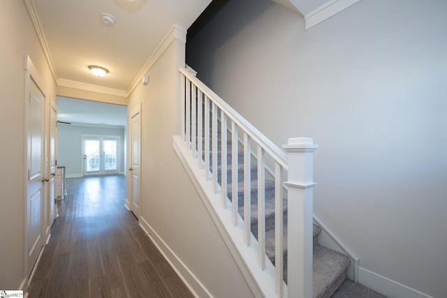 staircase featuring crown molding and hardwood / wood-style flooring