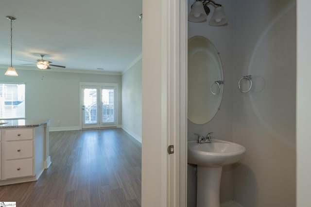 bathroom featuring hardwood / wood-style flooring, ceiling fan, and ornamental molding