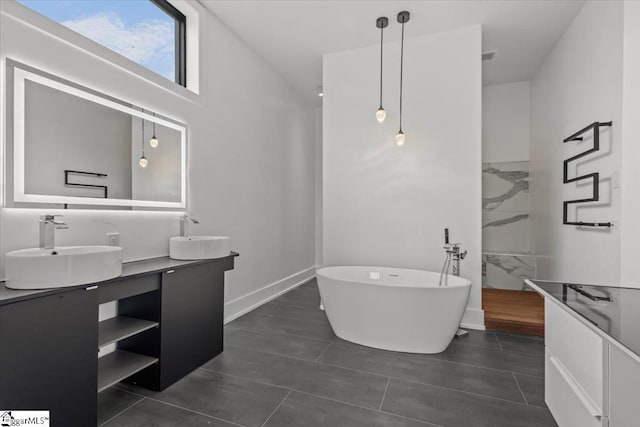 bathroom featuring vanity, a tub, and tile patterned floors