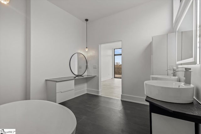 bathroom with vanity and a tub