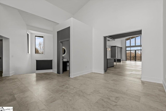 unfurnished living room with lofted ceiling