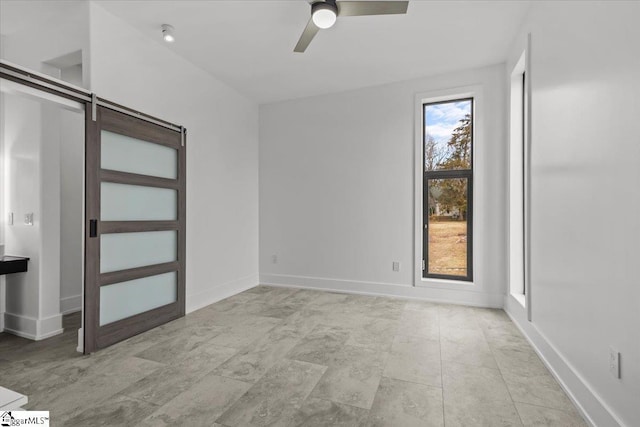 unfurnished room with ceiling fan and plenty of natural light