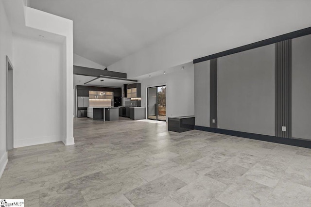 unfurnished living room with high vaulted ceiling