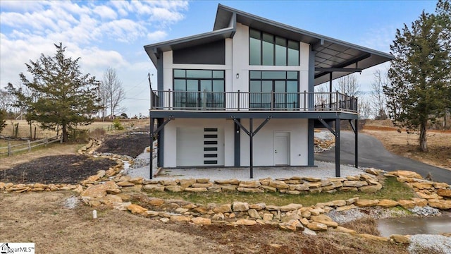 rear view of house featuring a deck