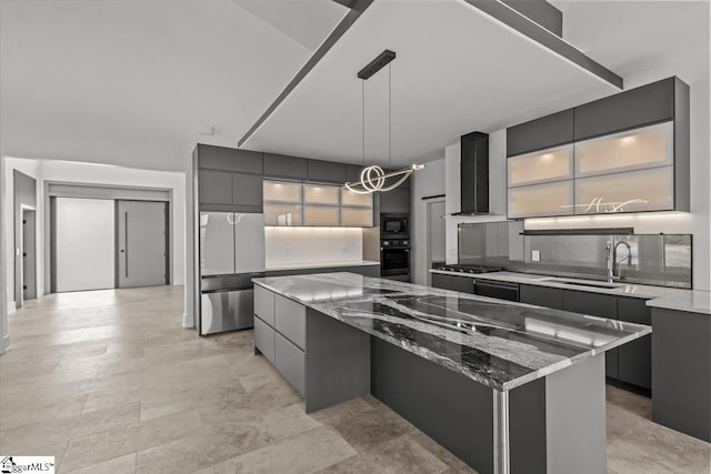 kitchen with a spacious island, wall chimney exhaust hood, sink, pendant lighting, and black appliances