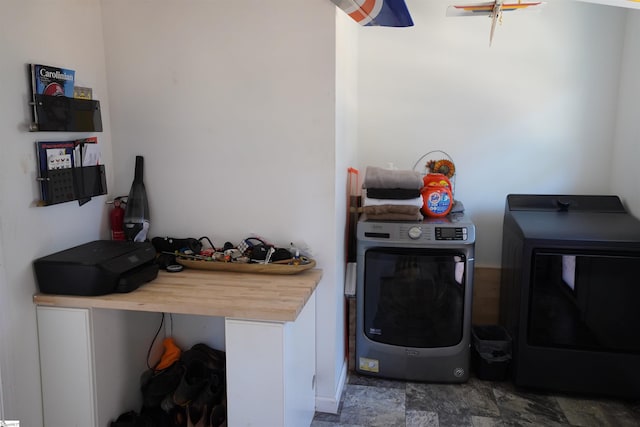 laundry room with separate washer and dryer and cabinets