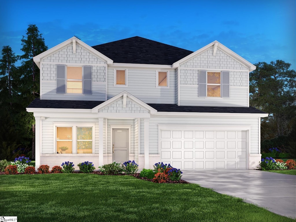 view of front of home featuring a garage and a front yard