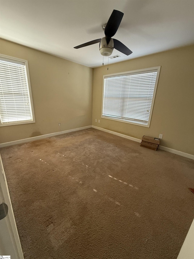 unfurnished room with ceiling fan and carpet floors