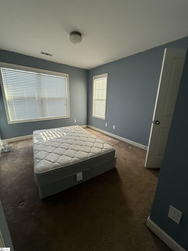 bedroom with dark carpet