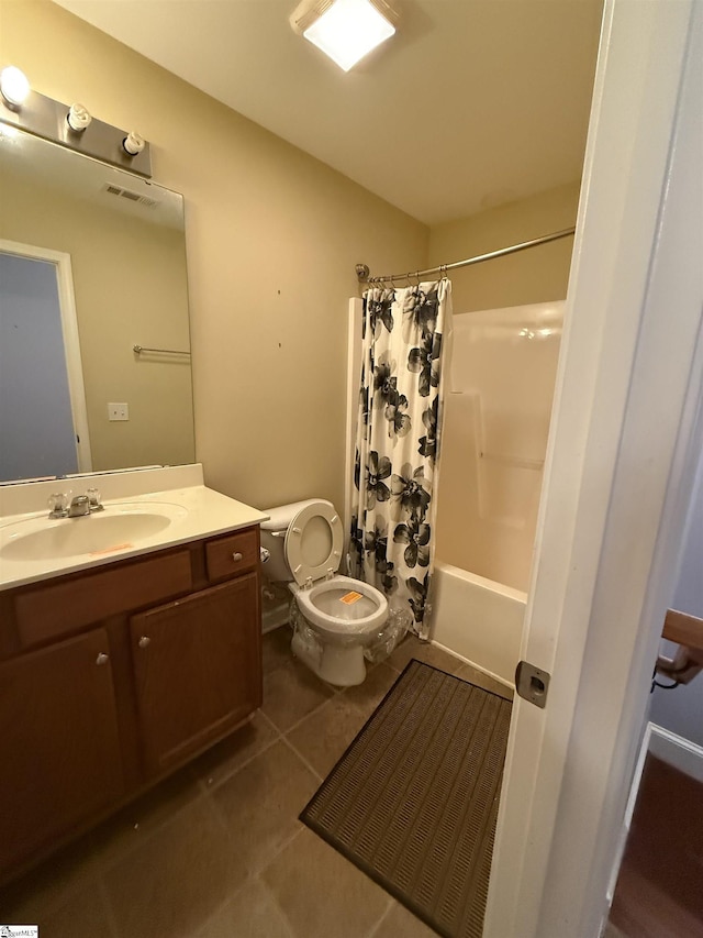 full bathroom with tile patterned flooring, vanity, toilet, and shower / bath combo with shower curtain