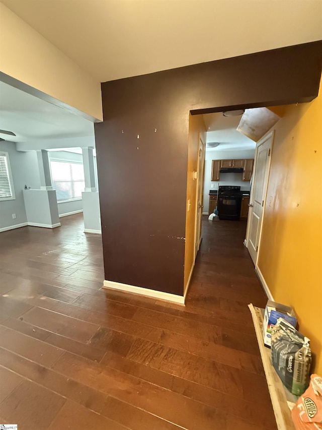 hallway with dark hardwood / wood-style flooring