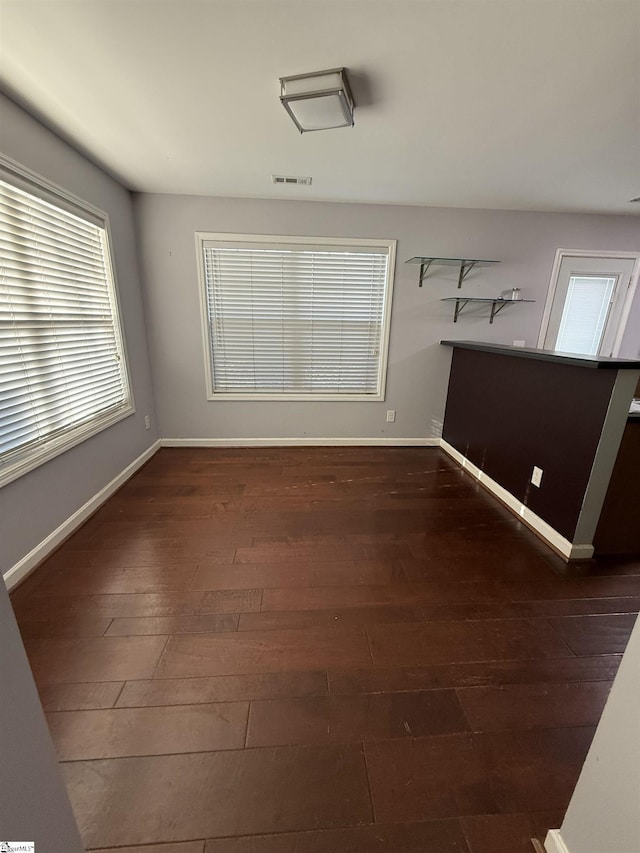 spare room featuring dark hardwood / wood-style flooring