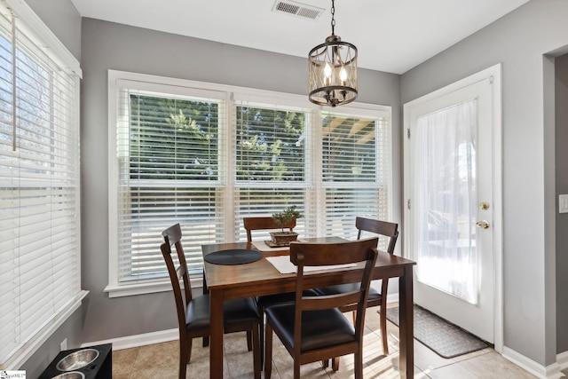 dining space with a chandelier and light tile patterned floors