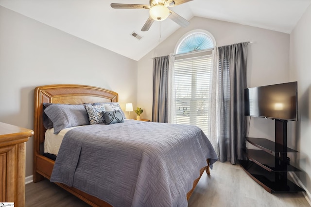 bedroom with lofted ceiling, ceiling fan, and light wood-type flooring