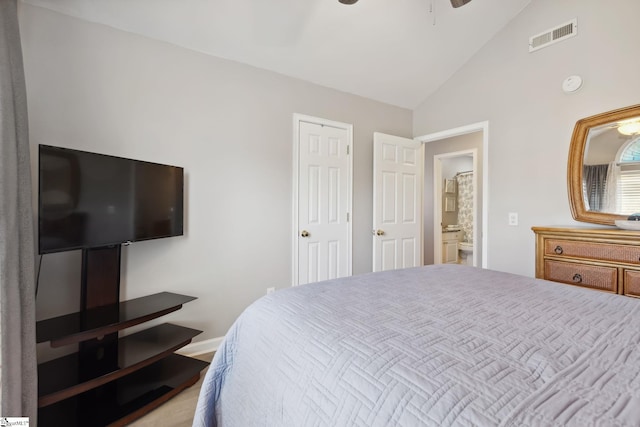 bedroom with high vaulted ceiling, connected bathroom, and ceiling fan