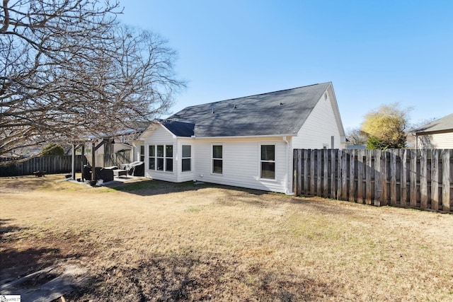 rear view of house featuring a patio area and a lawn