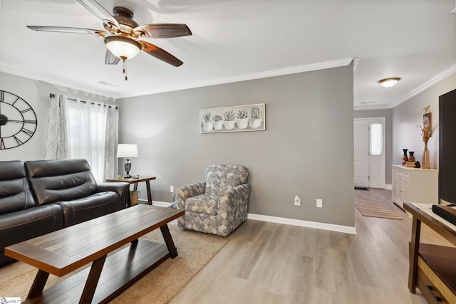 living room with ceiling fan, ornamental molding, and light hardwood / wood-style floors