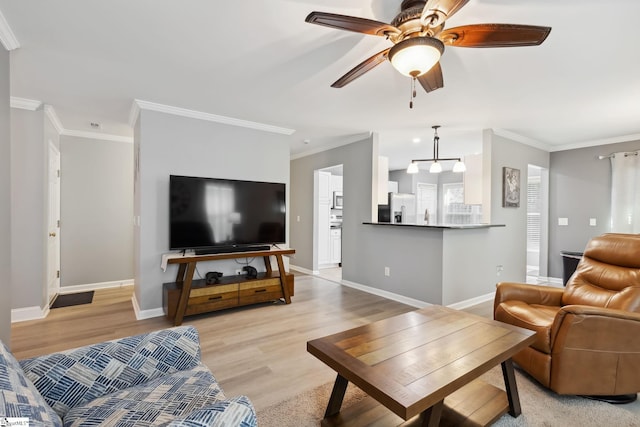 living room with crown molding, light hardwood / wood-style flooring, and ceiling fan