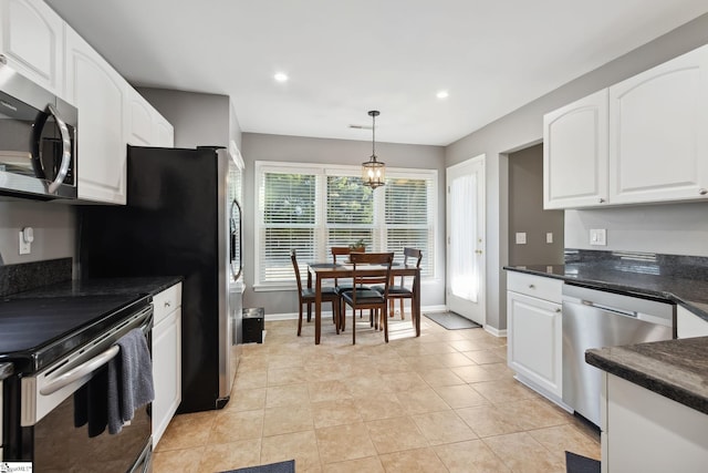 kitchen featuring white cabinetry, appliances with stainless steel finishes, light tile patterned flooring, and hanging light fixtures