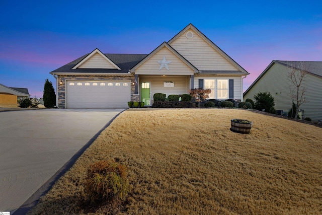 view of front of property featuring a garage and a yard