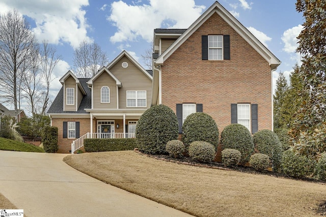 view of front property featuring a porch and a front lawn