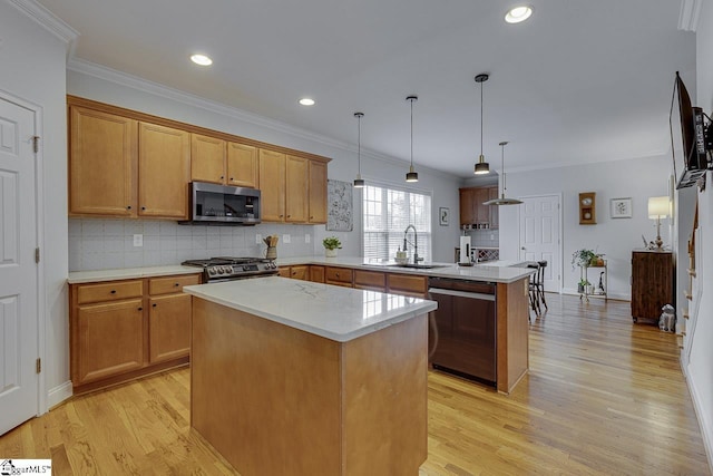 kitchen featuring pendant lighting, appliances with stainless steel finishes, ornamental molding, a kitchen island, and kitchen peninsula