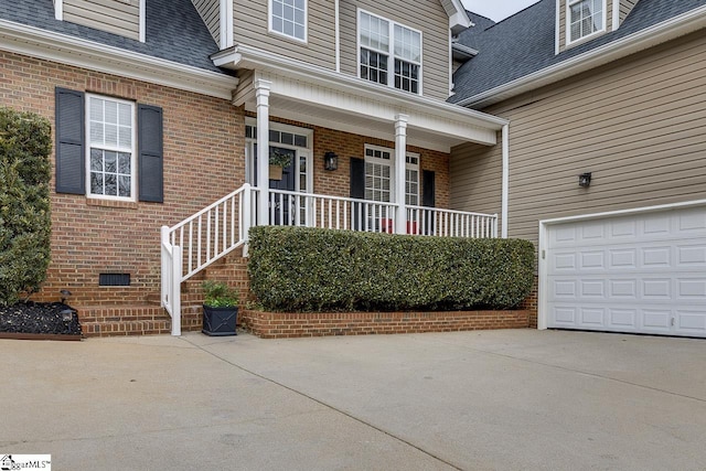 property entrance with a porch and a garage