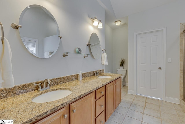 bathroom with vanity, tile patterned floors, and toilet