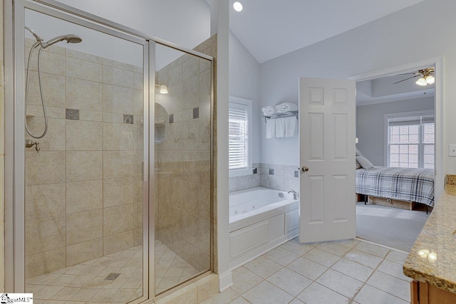 bathroom featuring lofted ceiling, plenty of natural light, tile patterned floors, and separate shower and tub