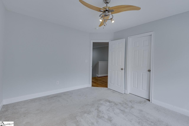 unfurnished bedroom with ceiling fan and light carpet