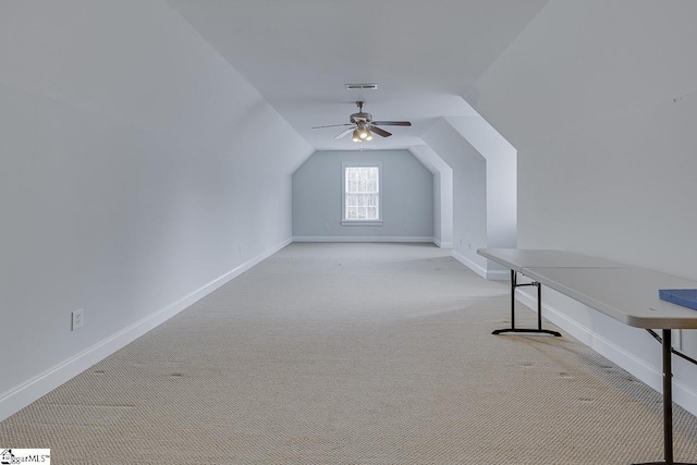 additional living space featuring lofted ceiling, light carpet, and ceiling fan