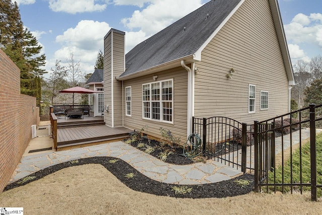 view of property exterior with a wooden deck