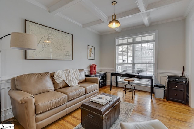 living room featuring coffered ceiling, light hardwood / wood-style flooring, ornamental molding, and beamed ceiling