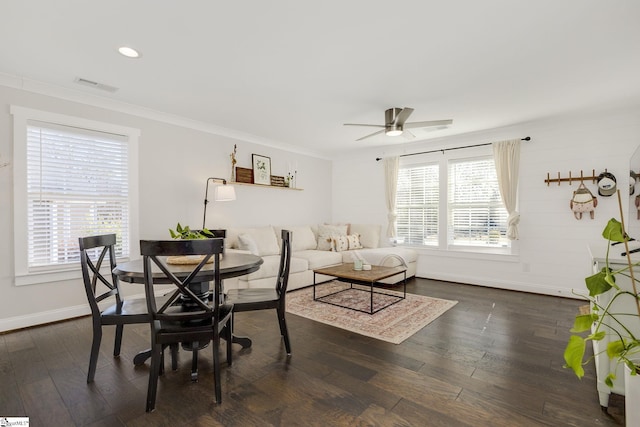 dining space with ornamental molding, dark hardwood / wood-style floors, and ceiling fan