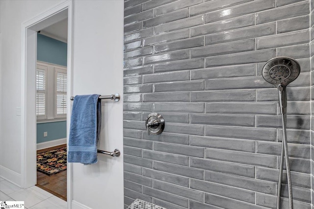 bathroom featuring tile patterned flooring and tiled shower