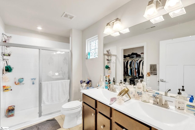 bathroom with vanity, tile patterned flooring, a shower with shower door, and toilet