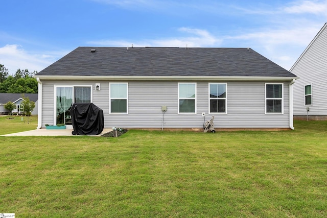 back of property featuring a lawn and a patio area